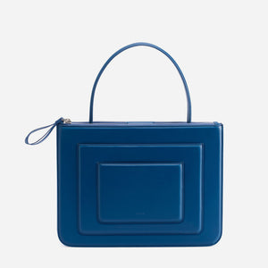 Front view of blue rectangular purse with small handle