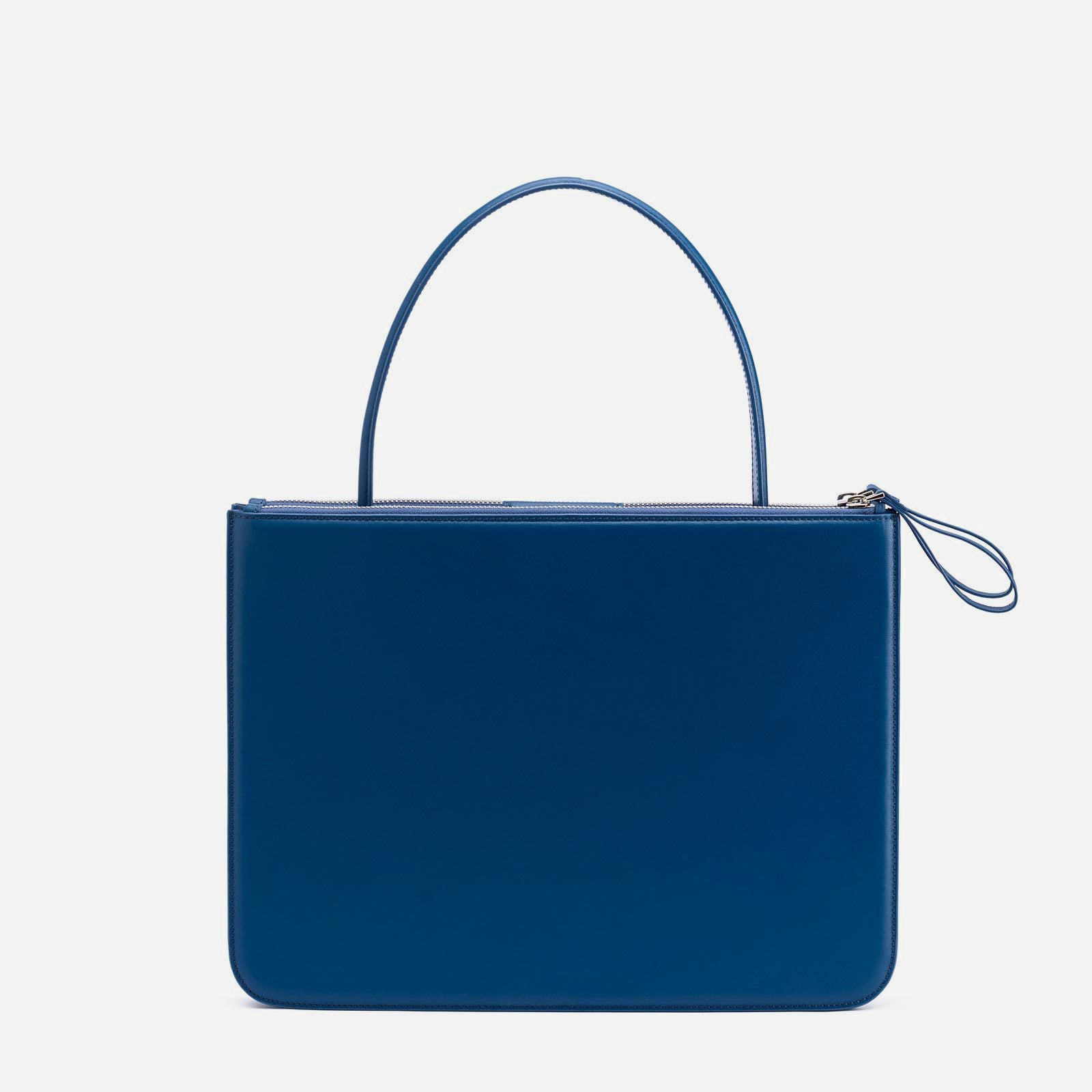 Back view of blue rectangular purse with small handle